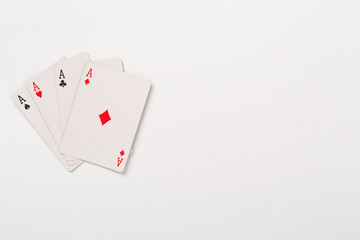 Poker chips and playing cards on color background, top view. Casino card game