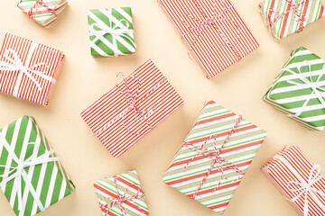 Obraz premium Many striped Christmas gift boxes on color background, top view