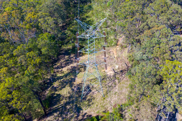 Drone aerial photograph of an electrical transmission tower running through regional bushland in the Blue Mountains in NSW, Australia.