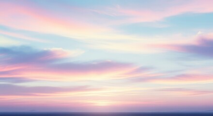 Obraz premium Dreamy pastel sky with soft clouds reflecting warm sunset hues over a calm ocean horizon