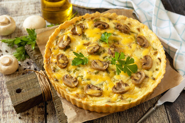 Delicious homemade mushroom quiche with mushrooms and green beans on rustic table.