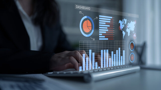 A business professional engages with a holographic dashboard that showcases data analytics, featuring various charts, graphs, and a world map in an office setting. Impute