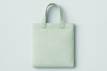 Minimalist eco-friendly tote bag in soft mint green, crafted from textured fabric with clean stitching and simple handles, showcased on a matching pastel background for a fresh, modern look