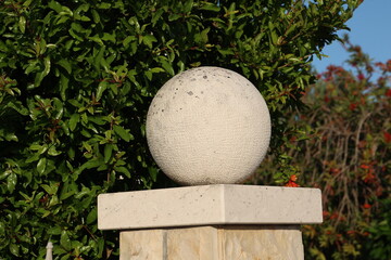 Decorative ball on a stone fence