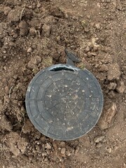 Black drainage well with lid. Broken lid. Vertical