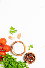 Kitchen table with herbs, spices and vegetables.