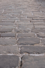 Obraz premium Abstract background of old cobblestone pavement close-up.