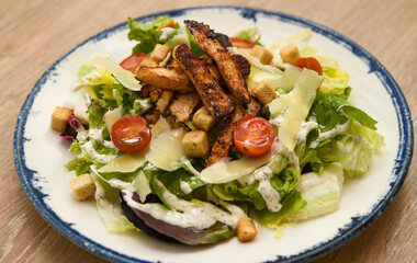 Caesar salad with grilled chicken and cherry tomatoes, close-up