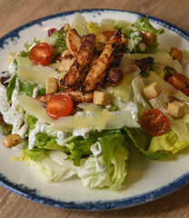 Caesar salad with grilled chicken and cherry tomatoes, close-up