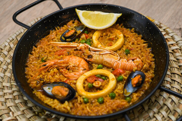 Spanish paella with seafood on a wooden table. Traditional spanish dish