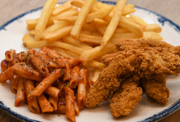 crispy fried chicken strips, French fries, and penne pasta with tomato sauce