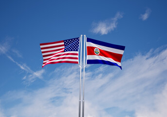 flags of  costa rica and United States of America over blue sky background.