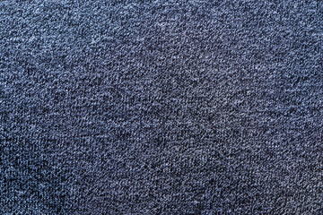 A close-up view of a textured dark blue fabric showcasing intricate patterns. Ideal for fashion, textiles, and design backgrounds in various creative projects.