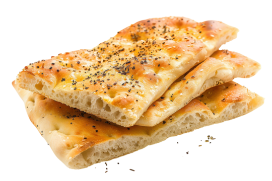 Freshly baked focaccia bread with herbs and spices stacked on a white background