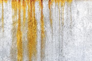 Weathered rusty wall with orange streaks on textured concrete surface
