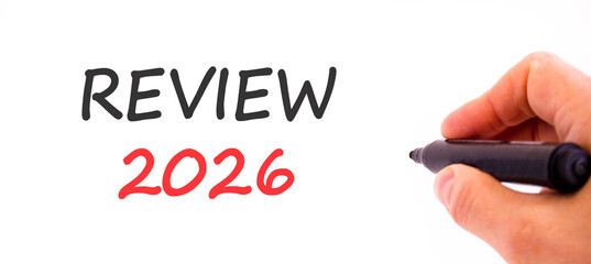 Review 2026 symbol. Concept words Review 2026 on beautiful white paper. Beautiful white paper background. Businessman's hand with pen. Business and review 2026 concept. Copy space.
