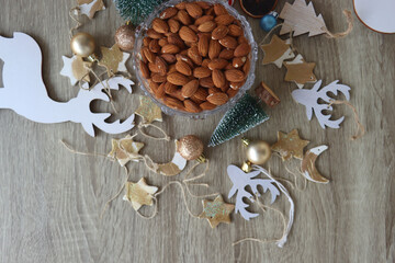 Various Christmas decorations, cookies, chocolate and nuts on wooden background. Flat lay.