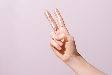 Two Finger Sunscreen Rule Concept on Pink Background