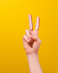 Two Finger Sunscreen Rule Concept on Yellow Background