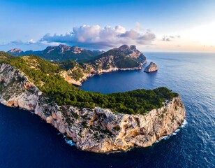 Panoramic aerial view of a Mediterranean cove.  Coastal cliffs, lush vegetation, and a calm blue sea meet at sunrise