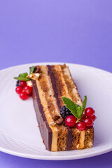 Chocolate cake with berries - top view on purple, luxury in every layer