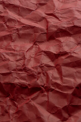 Fototapeta premium Crumpled red paper as background. Close up.