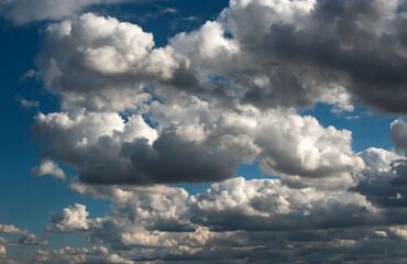Dramatic sky with voluminous, cumulus clouds, background