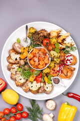 top view of stewed meat with potatoes and onions, an appetizing dish on a white plate