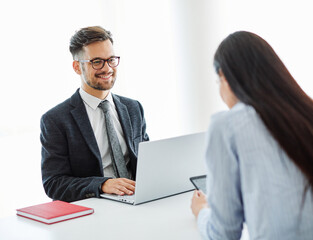 Real estate agent with couple meeting in office
