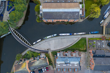 Top-down aerial image of Castlefield Footbridge and Merchants’ Warehouse along Bridgewater Canal in Manchester.