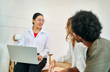 Fototapeta premium Young couple listening their financial advisor or a real estate agent who is using laptop during a meeting in the office or in a new property