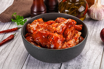 Raw marinated buffalo chicken wings