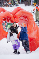 two girls show a heart with their hands