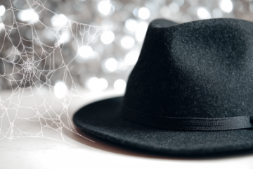 Black fedora hat with a spiderweb Halloween themed perfect for party invitations or spooky designs