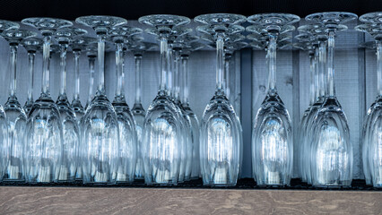 Elegant glassware arranged in a row, showcasing their intricate designs and reflections, highlighting the craftsmanship and beauty of fine dining table settings