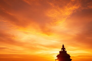 Serene Enlightenment: A silhouette of a Buddha statue against a vibrant, fiery sunset, evoking a sense of peace, contemplation, and spiritual awakening.