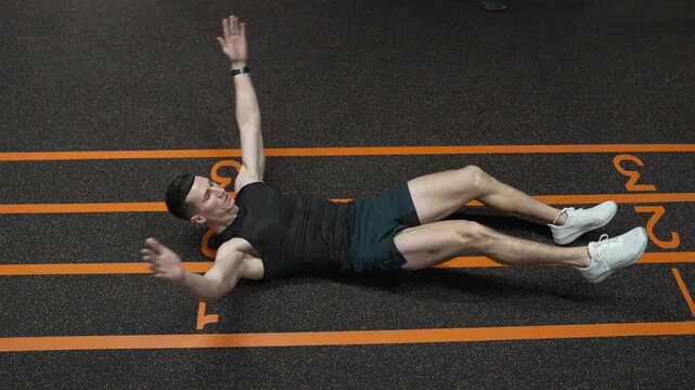 Sixpack leg crunches exercise. Muscular sportsman do abs workout. Abdominal exercise. Exercise for abs sixpack torso muscle. Leg crunches man in training. Sporty man training abs. Slow motion