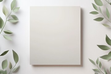 Elegance Canvas with Leafy Border: A pristine blank canvas is adorned by fresh, green foliage, the scene inviting a fresh start and artistic creation in natural light.