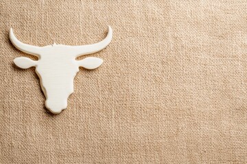 Bull Head on Canvas: A simple bull head silhouette placed on a natural canvas background, representing the raw beauty of nature and the spirit of strength. 