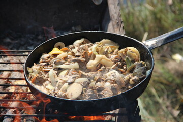 Cooking fried mussels in frying pan. Frying fresh mussels and onions