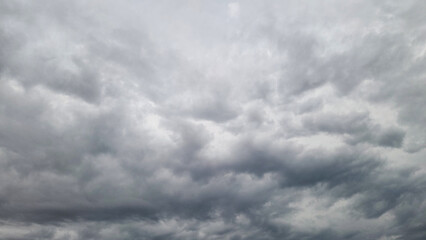 The sky is fully obscured by dark, featureless Nimbostratus and thick Stratocumulus, confirming the...