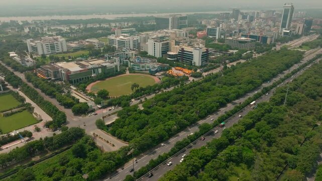 Aerial view of the Noida-Greater Noida Expressway, a vibrant scene of buildings, roads, and trees, creating a dynamic urban landscape, Noida, Uttar Pradesh, India.