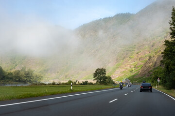 Driving car on road with forests in Calmont region with steepest vineyard in Europe on Moselle...