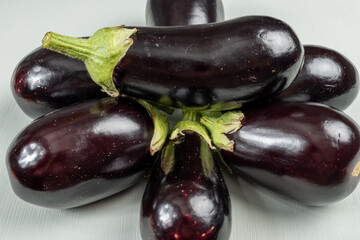 Group of small garden-fresh organic eggplants vegetables on table