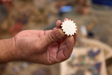 A student at a ceramics school in Fez holds a carefully shaped piece of clay, highlighting the artistry involved in traditional Moroccan pottery