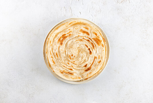 Traditional Indian paratha on white background. Indian food. Top view. 