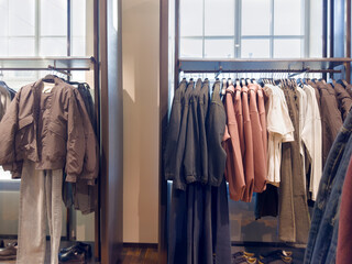 young man choosing clothes in a shopping mall. clothes hangers