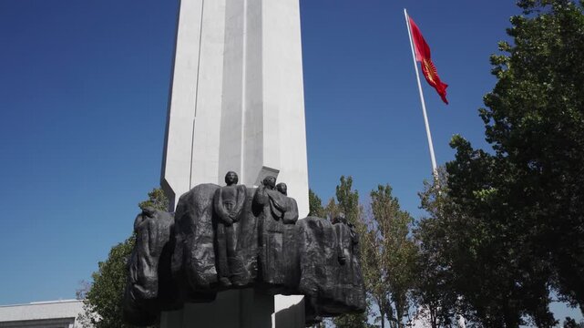 Detail of the national flag of Kyrgyzstan waving in the wind on a clear day.
