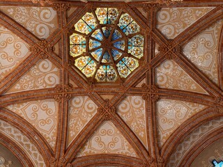 BARCELONA, SPAIN – OCTOBER 6, 2025: Interior view of an ornate historic hall with stained glass dome and decorative wall architecture.