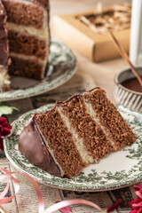 Slice of chocolate layered cake on rustic plate for birthday celebration close up